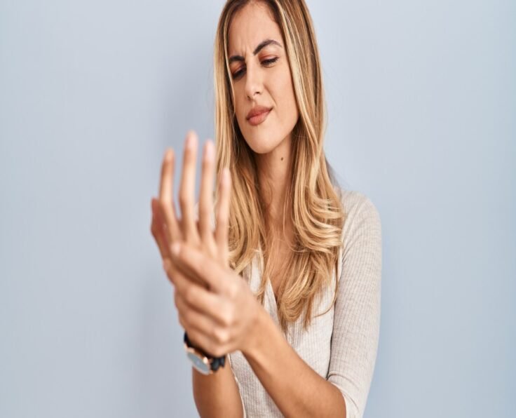 young-blonde-woman-standing-isolated-background-suffering-pain-hands-fingers-arthritis-inflammation (1)